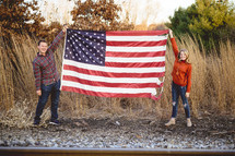 couple holding up an American flag 