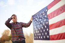 man saluting an American flag 