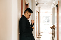 a groom standing in a hallway 