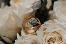 engagement ring on a bouquet of white roses 