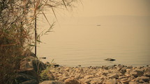 Sea of Galilee in the early morning, ripples on the water and boat. Israel.
