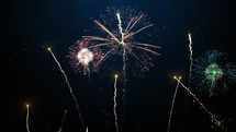 Brightly colorful fireworks for New Year and other events celebration on dark blue background. 