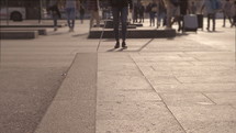 a blind man crossing  a street 
