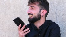 Man with phone happily talking