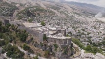 Aerial Panoramic of Castle of Gjirokastra above old city, south Albania
