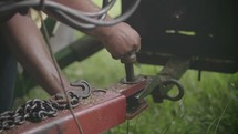 a farmer hooking up a tractor 