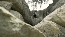 people climbing over rocks 
