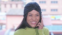a smiling woman talking on a cellphone 