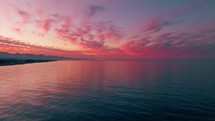 Pink And Purple clouds over the calm ocean