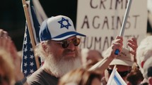 A man in the crowd with a Star of David standing among Israel supporters