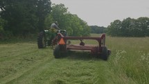 a man driving a bailing tractor 