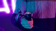 Close up of a hand holding a joystick while playing a virtual reality game.