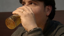 Man drinking a beer.