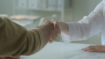 Handshake between Female Doctor and Patient on Consultation in Clinic
