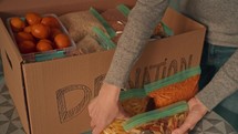 Packing up a box of food to donate