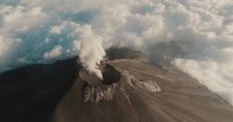Smoke coming out of Fuego volcano eruption in Guatemala. Aerial drone orbit	