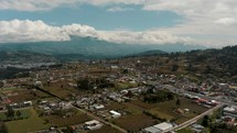 Expansive Otavalo City In The Andean Highlands Of Imbabura Province, Northern Ecuador. Ascending Drone Shot