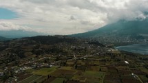 Aerial View Of Cultivated Lands At The Bottom Of Imbabura Volcano At San Pablo Lagoon In Otavalo, Ecuador. Aerial Pan Right