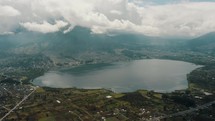 San Pablo Lagoon And Imbabura Volcano In Otavalo, Ecuador. wide aerial drone