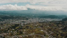 Aerial Panorama Of Agricultural Lands And Town Villages In San Pablo Lagoon Near Otavalo, Ecuador. Pan Left Shot