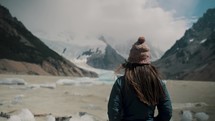 Woman Standing By The Laguna Torre With Cerro Torre View In Los Glaciares National Park, Argentina. back view, slow motion