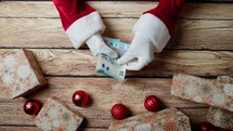 Santa Claus counting money for Christmas presents 