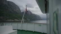 	riding a ship through the lysefjord in norway with norwegian flag