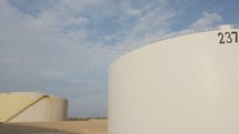 Large crude oil storage tanks in a huge refinery.