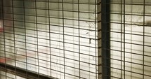 Abstract textures and patterns- grey metal grid door with metal plates