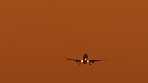 passenger airfreight Boeing against orange sunset sunrise sky 