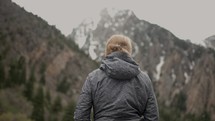 Young woman looking around at stunning mountains