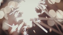 Close up of lit sparklers being waved