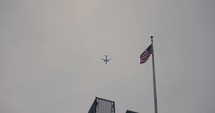 Plane flying by USA flag