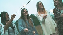 friends holding sparklers 