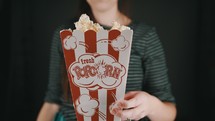 a woman eating popcorn 