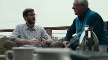 elderly man mentoring a young man 