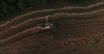 combine plowing a field 