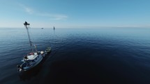 Boat heads towards the coast of Scilla city near ocean