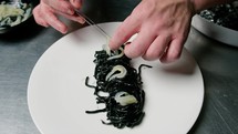 Chef Cooking Black Ink Cuttlefish Italian Spaghetti Food At Restaurant