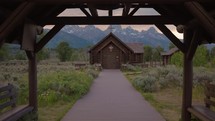 Old Wooden Chapel in the Mountains at Sunset