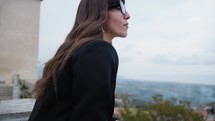 Woman Dressed In Black Looking Out From The Balcony Of Gerace