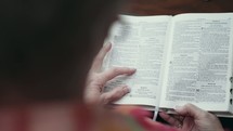 elderly woman reading a Bible at a Bible study 