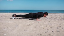 Boy Does Push Up Exercises In Outdoor Gym On The Beach Near The Sea