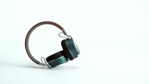 falling headphones against a white background