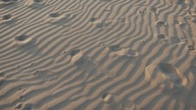 Dunes of beach in Sicily and footprints