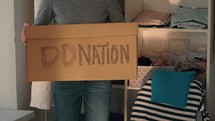 Packing up a box of clothes to donate