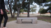 Man With Black Suit Sits On A Bench To Rest