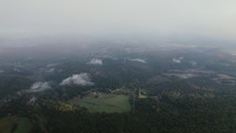 Aerial Shot Through Fog and Mountains