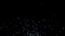 Blue particles rise from bottom on black background