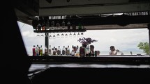 people walk past a bar in thailand